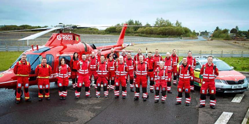 Group of medical staff in front of air ambulance