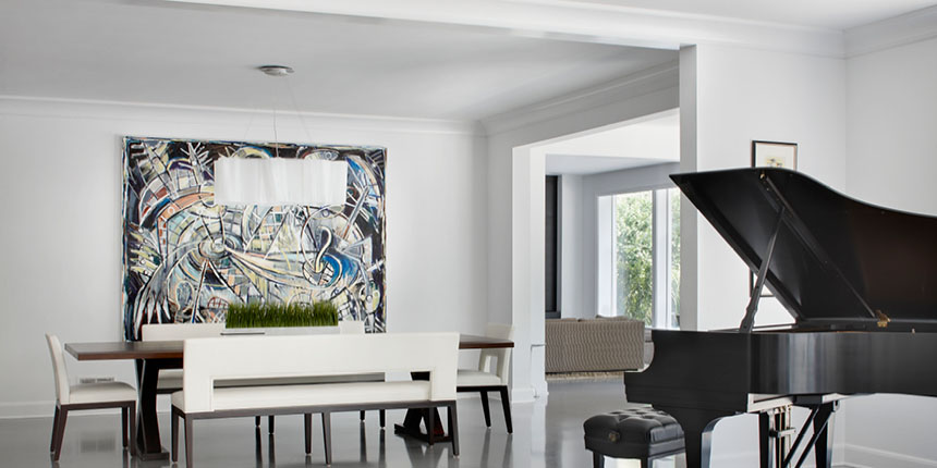 Open plan room with grand piano and modern painting