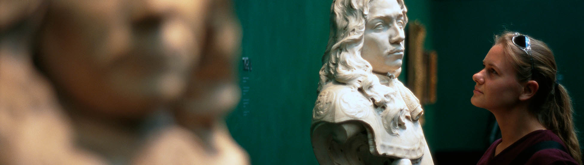 Woman looking at sculpture in museum