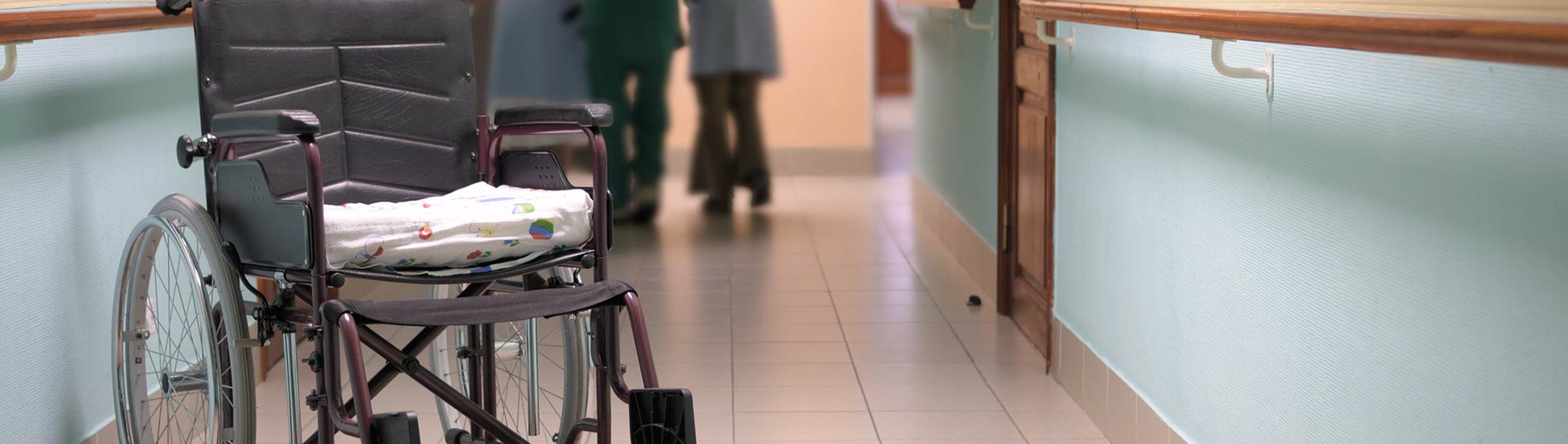 Wheelchair in care home corridor