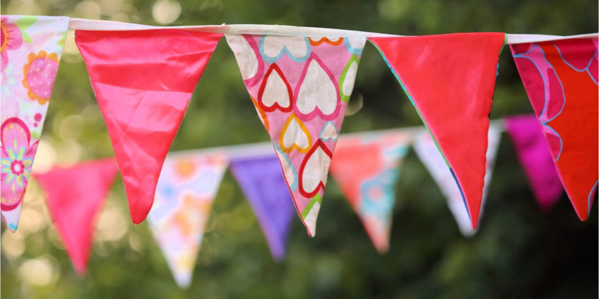 Brightly coloured bunting hanging up at outdoor event