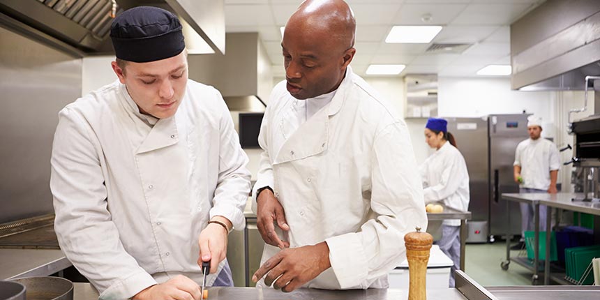 Catering teacher and student in kitchen
