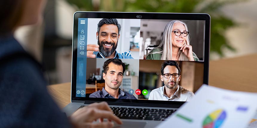 Laptop screen showing meeting of four people