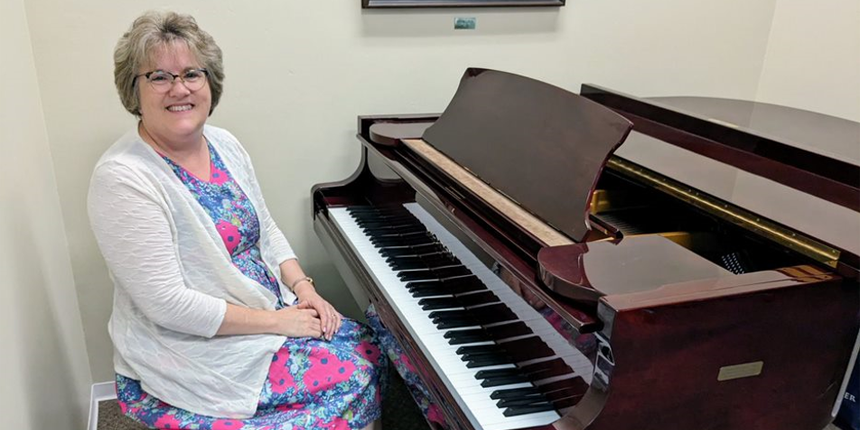 Rev Debbie Lord sat at a piano
