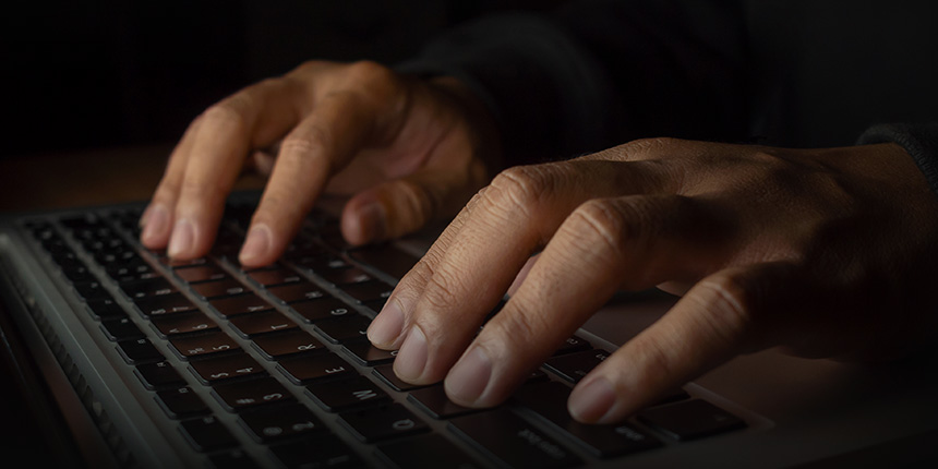 Hands working on a computer keyboard